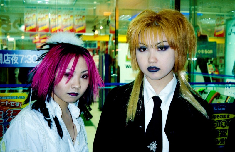 Punk style young women outside convenience store